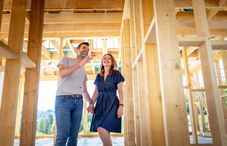 Couple holding hands on residential construction site