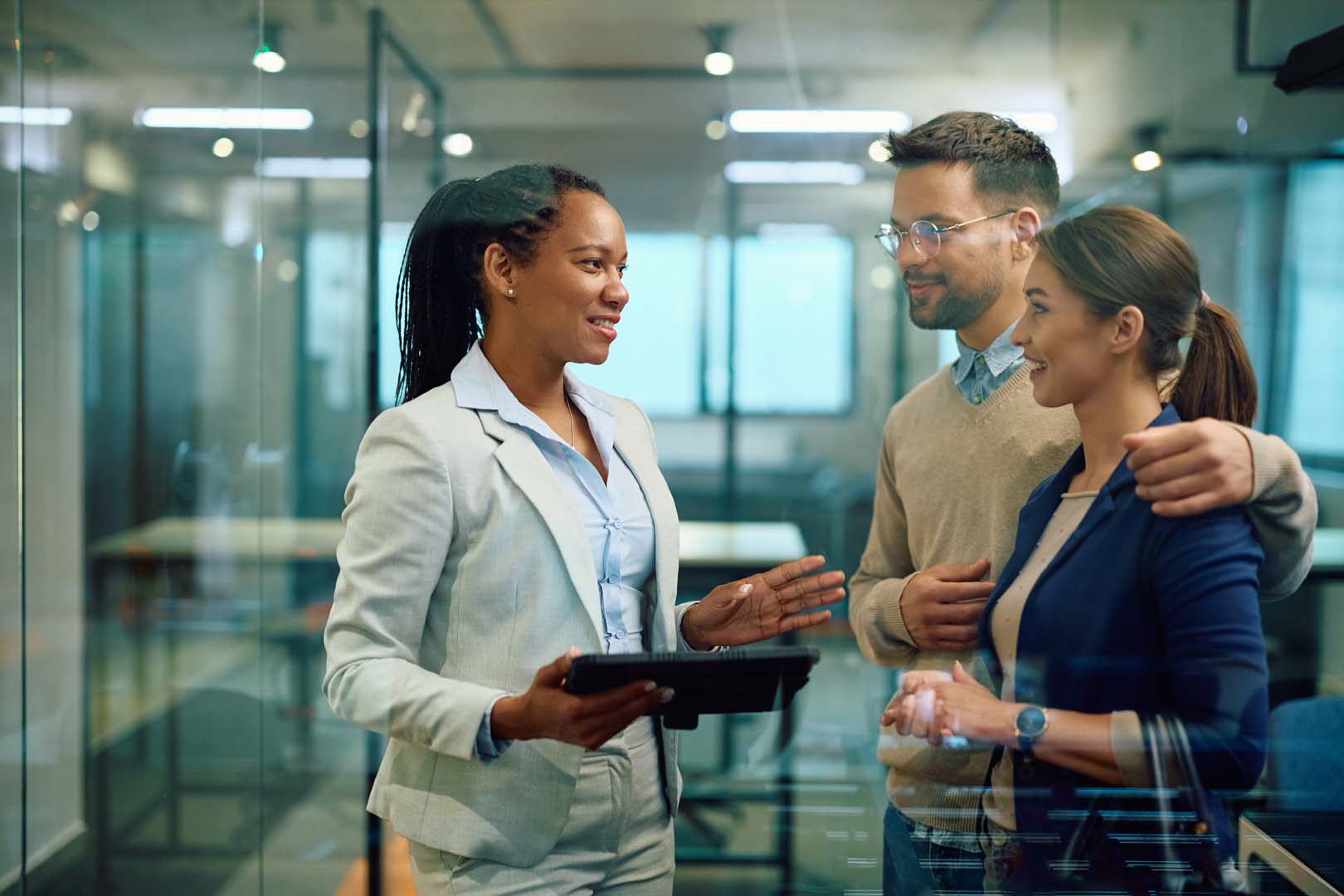 Couple and woman discussing loan options